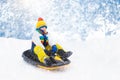 Boy on sled ride. Child sledding. Kid on sledge Royalty Free Stock Photo