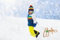 Boy on sled ride. Child sledding. Kid on sledge Royalty Free Stock Photo