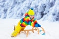 Boy on sled ride. Child sledding. Kid on sledge Royalty Free Stock Photo