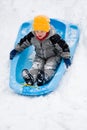 Boy sledding down hill Royalty Free Stock Photo
