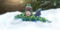 Boy sledding in a snowy forest. Outdoor winter fun for Christmas vacation. Royalty Free Stock Photo