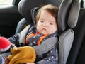 The boy is sleeping in a car seat. Driving safety for the child. 0-1 year old baby sleeping in a car seat