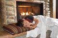 Boy sleeping in front of fireplace Royalty Free Stock Photo