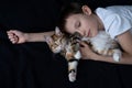 boy sleeping with small straight kurilian bobtail kitten