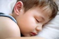 The boy is sleeping on a white pillow. Portrait of a sleeping child. Royalty Free Stock Photo