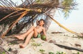 Boy sleeps in selfmade hut on tropical beach Royalty Free Stock Photo