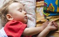 Boy sleeps on varicoloured pillows Royalty Free Stock Photo