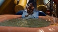A boy sliding down an inflatable water slide falls into a pool of water causing a flurry of splashes The child curls up and closes Royalty Free Stock Photo