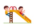 Boy sliding down slide and climbing up ladder