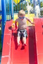 Boy sliding down a water slide Royalty Free Stock Photo