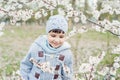 Boy smelling blooming apricot flowers Royalty Free Stock Photo