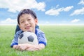 Boy smiles with his football on field Royalty Free Stock Photo