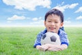 Boy smiles with his football on field Royalty Free Stock Photo