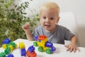 The boy smiles and plays with toys Royalty Free Stock Photo