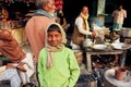 Boy with smiley face standing at outdoor cafe with tea-masala vendor Royalty Free Stock Photo