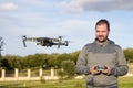 Boy smiling as a drone flies in front of him