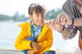 Boy smiling while granddad putting worm on fishing hook Royalty Free Stock Photo