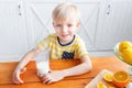 Boy are smiling while having a breakfast in kitchen. Mom is pouring milk into glass Royalty Free Stock Photo