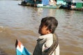 The boy with a snake. Tonle Sap Lake. Cambodia. Royalty Free Stock Photo