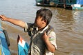 The boy with a snake. Tonle Sap Lake. Cambodia. Royalty Free Stock Photo