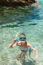 Boy with snorkel and mask in crystal clear sea water, enjoying beach family vacation. Snorkeling, swimming, water sports Royalty Free Stock Photo