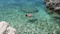 Boy with snorkel and mask explore underwater, swim in crystal clear water of Aegean Sea, Greece. family beach vacation Royalty Free Stock Photo