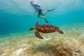 Boy snorkeling with sea turtle Royalty Free Stock Photo