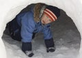 Boy in a snow cave.