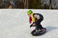 Boy Snowboarding on a Sled in Winter
