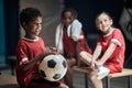 Boy with soccer ball in changing room Royalty Free Stock Photo