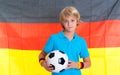 Boy with soccer ball in front of german flag Royalty Free Stock Photo