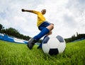 Boy soccer player hits the football ball Royalty Free Stock Photo