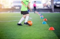 Boy soccer player trap and control football between cone makers