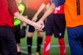 Boy soccer players tap hands together for football training