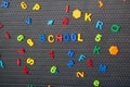 Boy spelling out the word school. Magnet letters Royalty Free Stock Photo