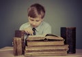 The boy spends time reading old books Royalty Free Stock Photo