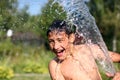 Boy with splash water in hot summer day Royalty Free Stock Photo