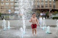 Boy and a splashing water fountain Royalty Free Stock Photo