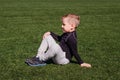 boy sitting on the green grass outdoors