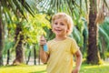 Boy spraying insect repellents on skin