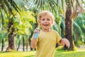 Boy spraying insect repellents on skin