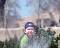 Boy spraying water Royalty Free Stock Photo