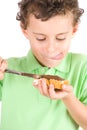 Boy spreading peanuts butter on bread Royalty Free Stock Photo