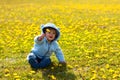 Boy in spring flowers field
