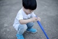 Boy squatting down and holdind toy Royalty Free Stock Photo