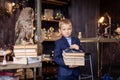 boy with a stack of books comes from the library. Smart schoolboy. Literature lesson. Classroom.