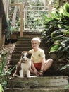 Boy on stairs with cute border collie puppy Royalty Free Stock Photo