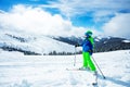 Boy stand on ski track in sport outfit observing the mountain Royalty Free Stock Photo