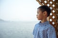 The boy stand at the waterside overlooking view at Bang Phra reservoir chonburi thailand