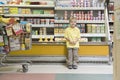 Boy Standing Against Fridge Counter In Supermarket